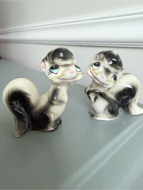 Antique  pair of salt and pepper shaker skunks with whiskers